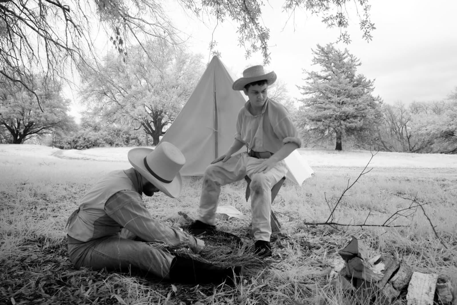 Two reenactors in period dress beside a canvas tent at the Texas Independence Day reenactment at Washington-on-the-Brazos.