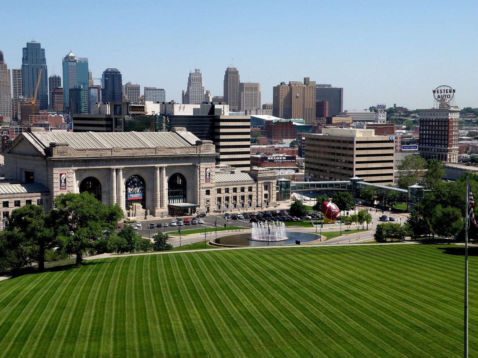 Union Station and the downtown Kansas City skyline beyond a striped green lawn.