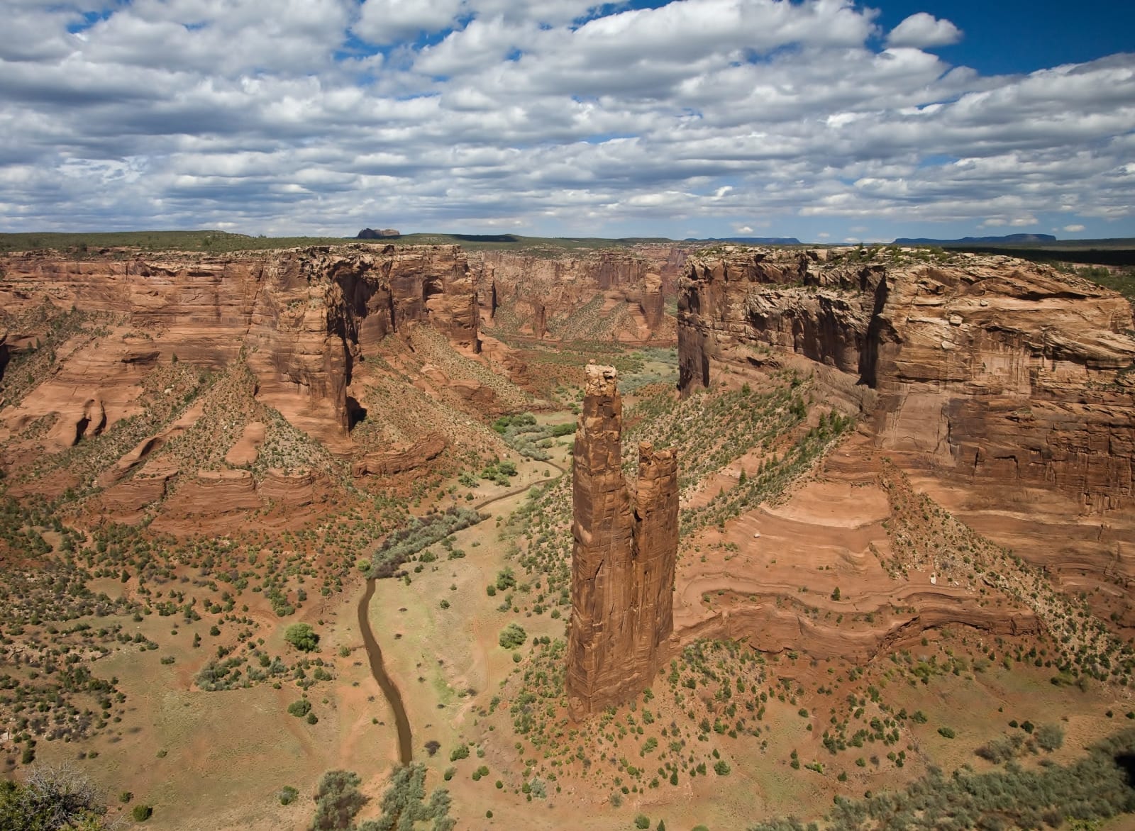 Spider Rock, the roughly 800-foot sandstone spire at the fork of Canyon de Chelly on the Navajo Nation, seen from the rim overlook.