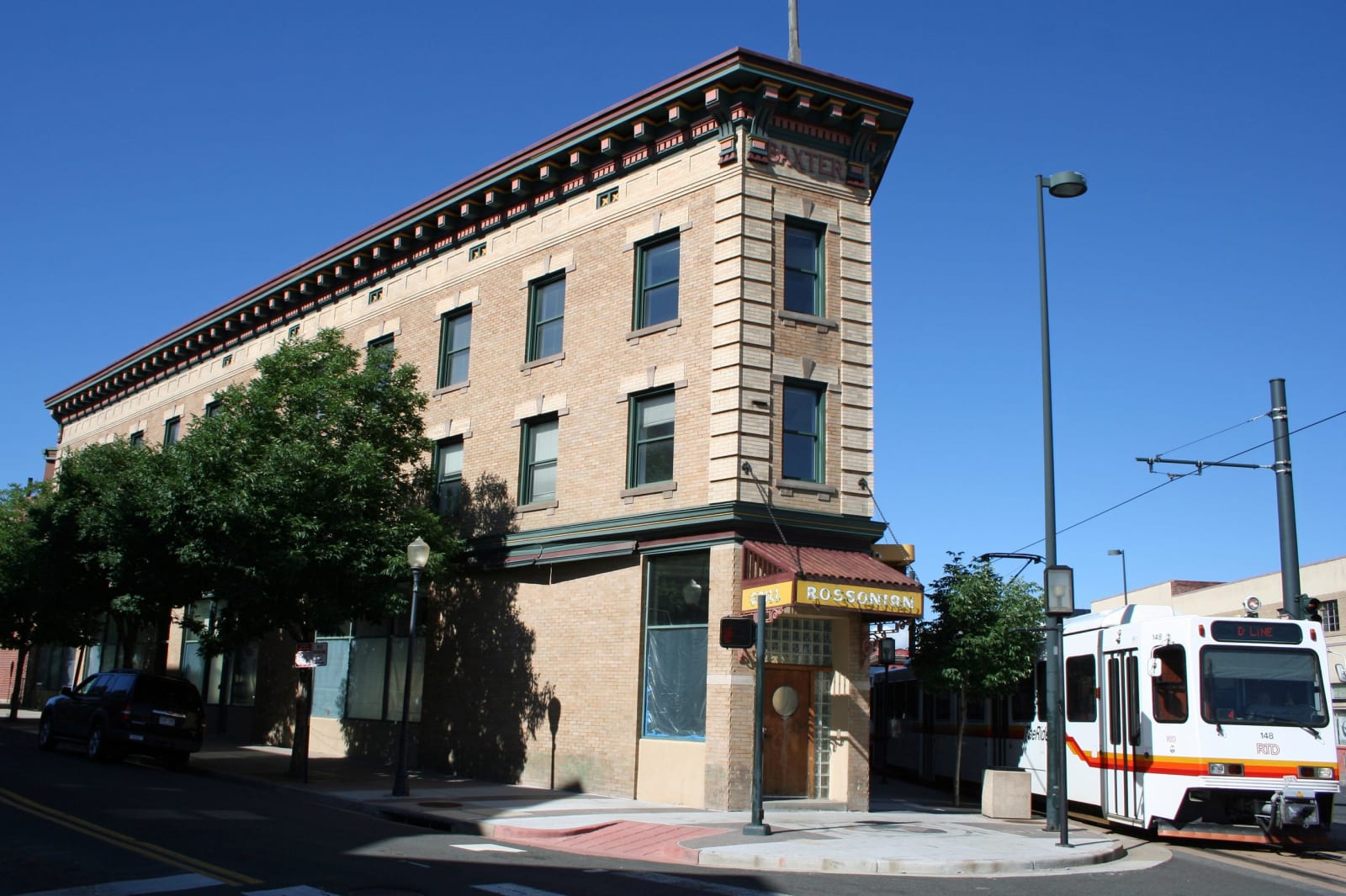 The Rossonian Hotel building at the Five Points intersection in Denver, a light-rail train passing
