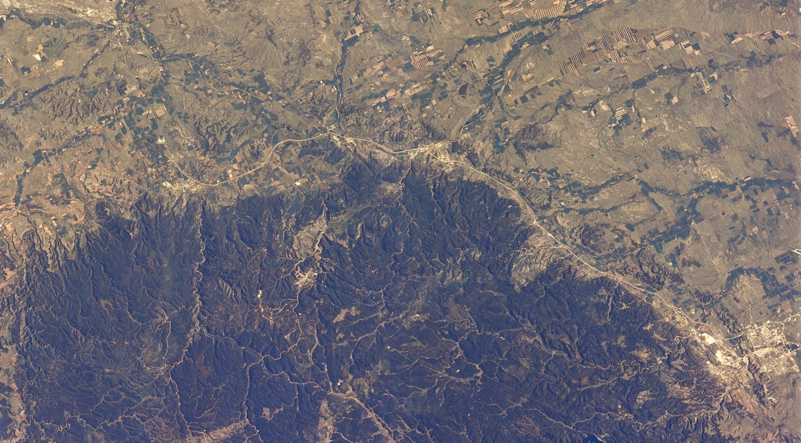 The Black Hills photographed from Skylab in June 1973, a dark forested dome ringed by paler plains and river valleys
