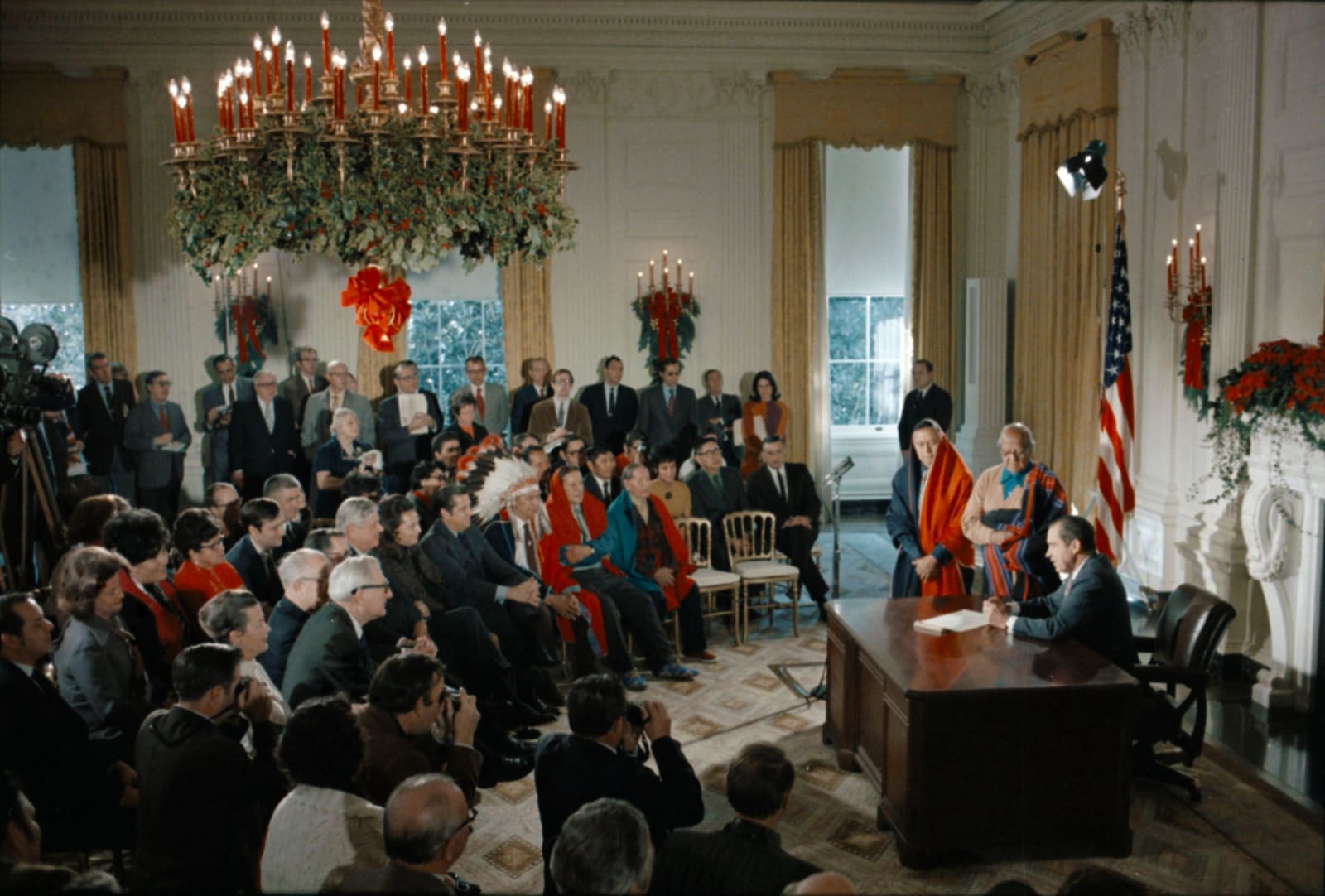 President Nixon at the signing ceremony for the Blue Lake bill in the White House State Dining Room on December 15, 1970, Taos Pueblo leaders seated beside him