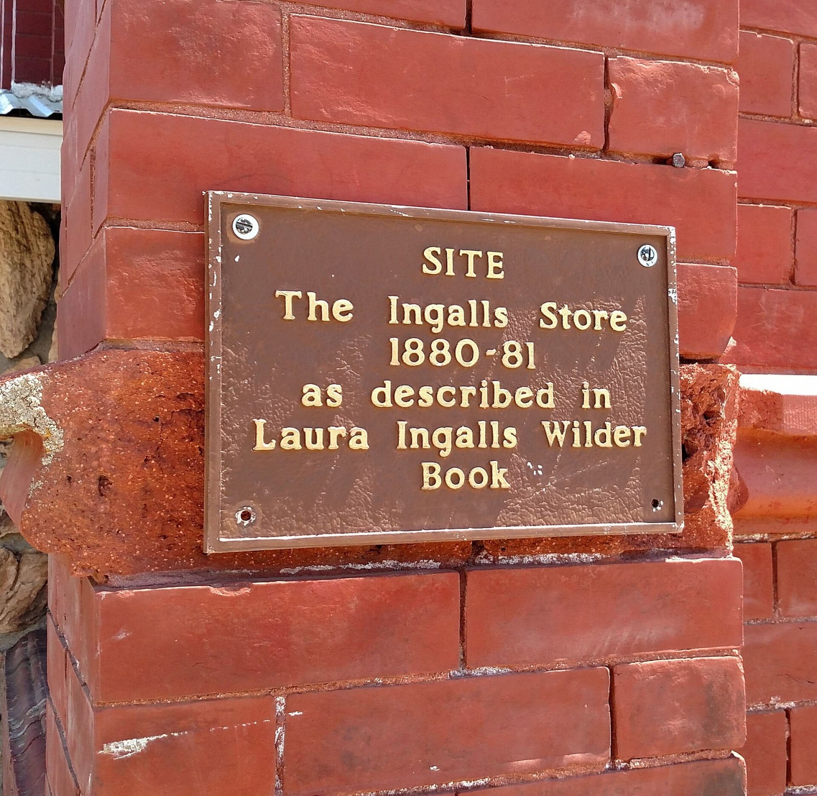 A bronze plaque on a brick building in De Smet marking the site of the Ingalls store of 1880 and 1881, where the family spent the Hard Winter