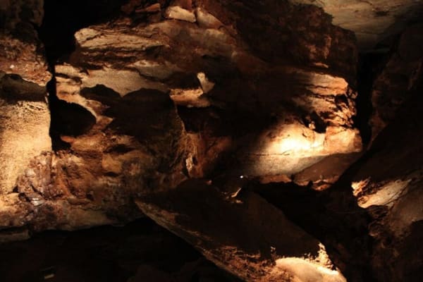 Lit gypsum walls and ledges inside Alabaster Caverns.