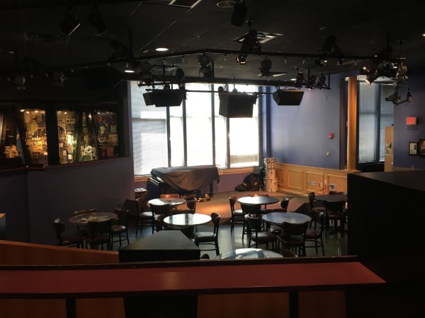 The Blue Room jazz club inside the American Jazz Museum, with its stage, bar and small tables.
