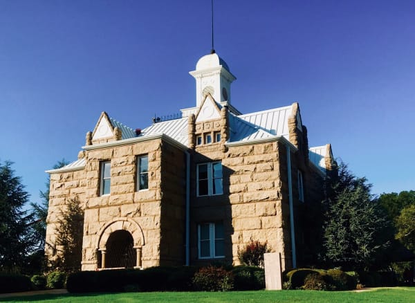 The red granite Chickasaw National Capitol in Tishomingo with its white cupola.