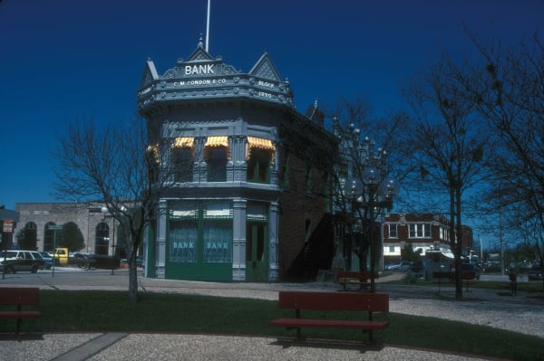 The restored Perkins Building in Coffeyville, which held the Condon Bank, with BANK lettered on its corner turret above a small plaza.