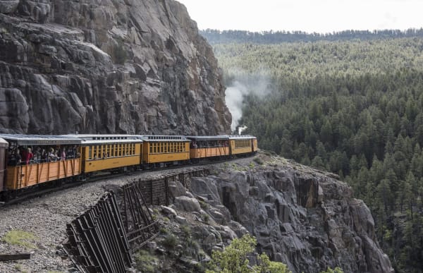 A Durango and Silverton steam train on the ledge high above the Animas River canyon