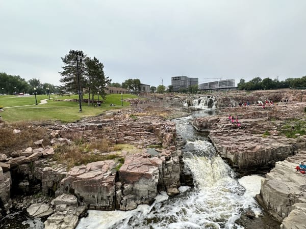 The Big Sioux River pouring through channels in blocky pink quartzite at Falls Park