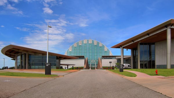 The First Americans Museum campus and its glass dome at the end of a long entry drive.
