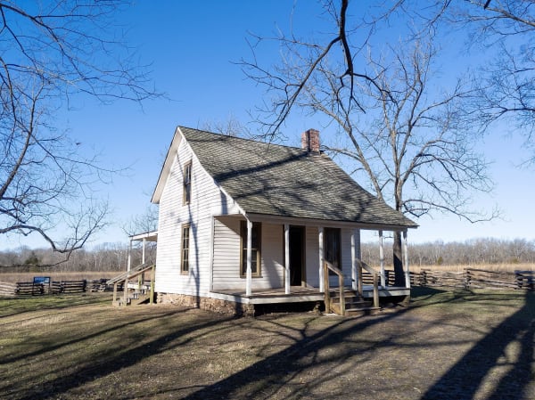 The white Moses Carver house under bare trees at George Washington Carver National Monument.