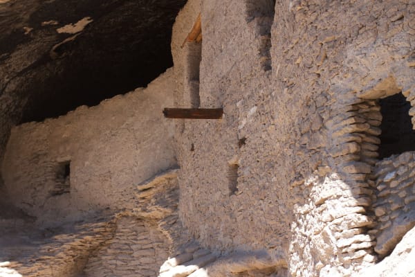 Stone masonry walls and doorways of the Gila Cliff Dwellings tucked beneath a cave overhang