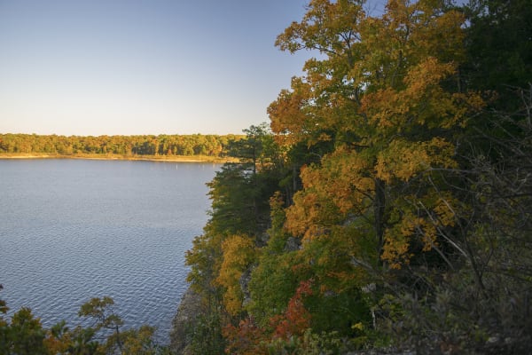 Truman Lake seen from the Bluff Ridge overlook, with oaks turning orange and gold on the bluff in fall.