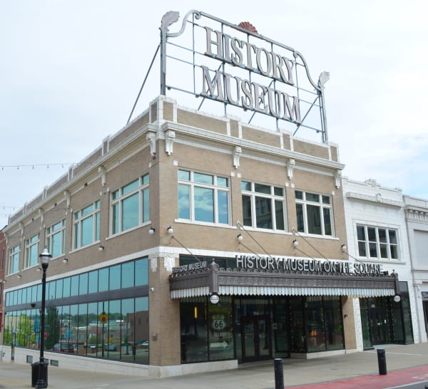The tan brick History Museum on the Square with its rooftop History Museum sign in Springfield.