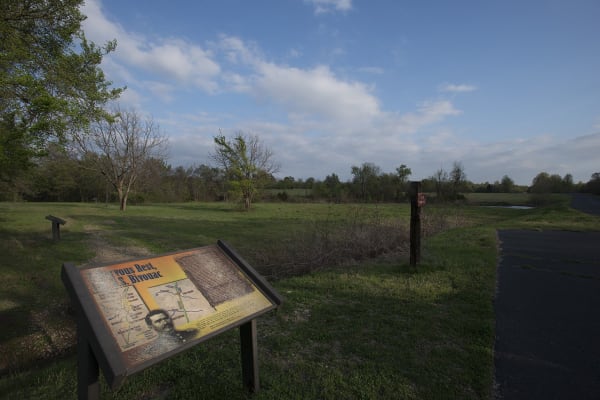 An interpretive sign in the open fields at Honey Springs near Rentiesville.