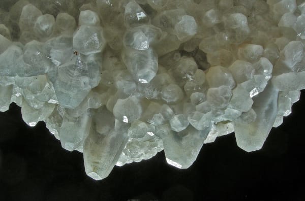 Translucent nailhead spar crystals of calcite crusting a surface in Jewel Cave