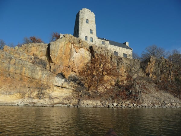 Tucker Tower standing on a rocky cliff above Lake Murray.