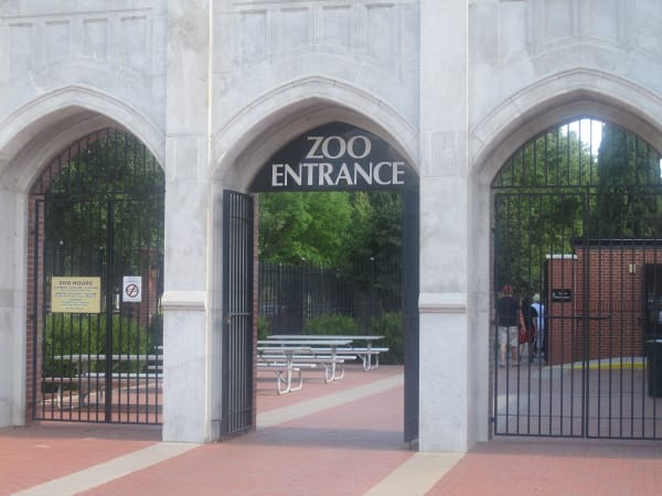 The pale stone arched entrance of Lee Richardson Zoo, its iron gates standing open.
