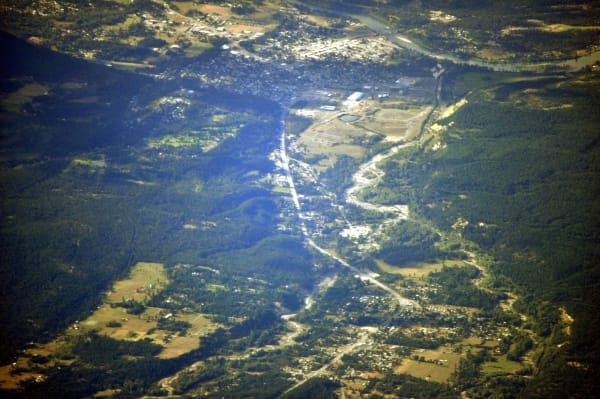 Libby from the air, the town spread along the Kootenai River valley between forested mountains