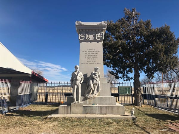 The 1918 granite monument at the Ludlow tent colony site, with its miner and family figures