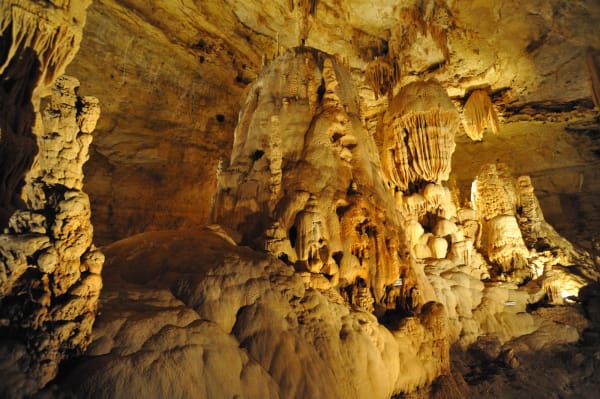 Lit flowstone and hanging formations filling a large chamber at Natural Bridge Caverns near San Antonio.