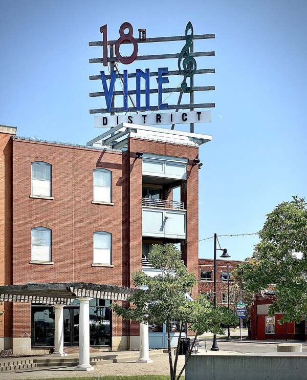 The 18th and Vine District sign atop a red brick building in the Kansas City jazz district where the museum stands.