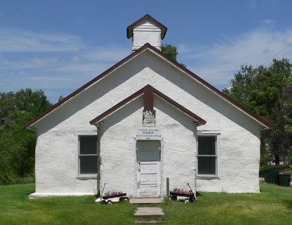 The thick white plastered walls and small belfry of the straw-bale Pilgrim Holiness Church in Arthur.