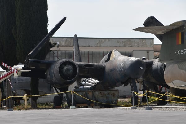 A Grumman F7F Tigercat parked nose-on among other aircraft outdoors at Planes of Fame in Chino.