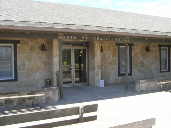 The stone front entrance of the Santa Fe Trail Center in Larned, its name lettered above the doors.