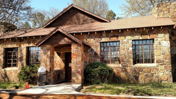 A stone building on the wooded grounds of the Sequoyah cabin site near Sallisaw.