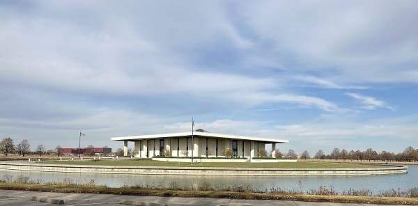 The white colonnaded Stuhr Museum pavilion sits on its island inside a circular moat in Grand Island.