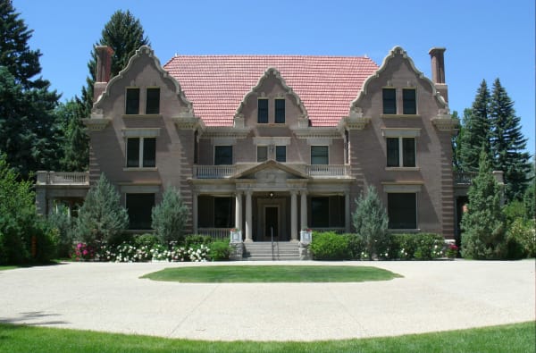 Trail End, the Kendrick mansion in Sheridan, a brick house with curving Flemish gables and a pillared porch behind a round lawn