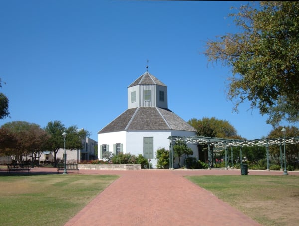 The white octagonal Vereins Kirche with its small cupola at the end of a brick walk across the Marktplatz in Fredericksburg.