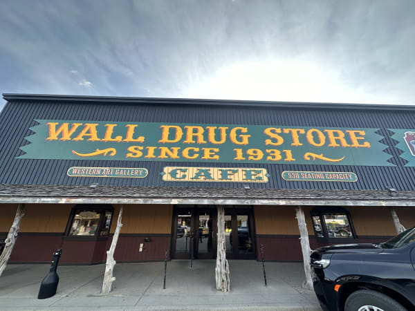 The long front of the Wall Drug Store under its painted sign reading Since 1931