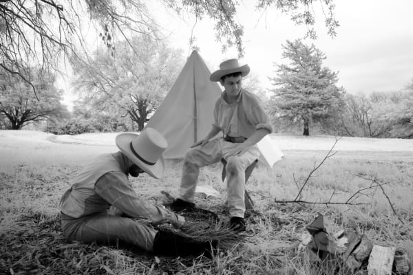 Two reenactors in period dress beside a canvas tent at the Texas Independence Day reenactment at Washington-on-the-Brazos.