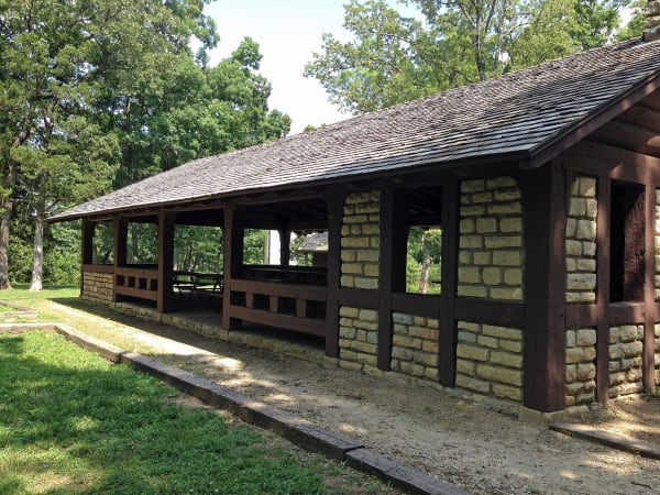 The long stone and timber CCC picnic pavilion under oak trees at Washington State Park.