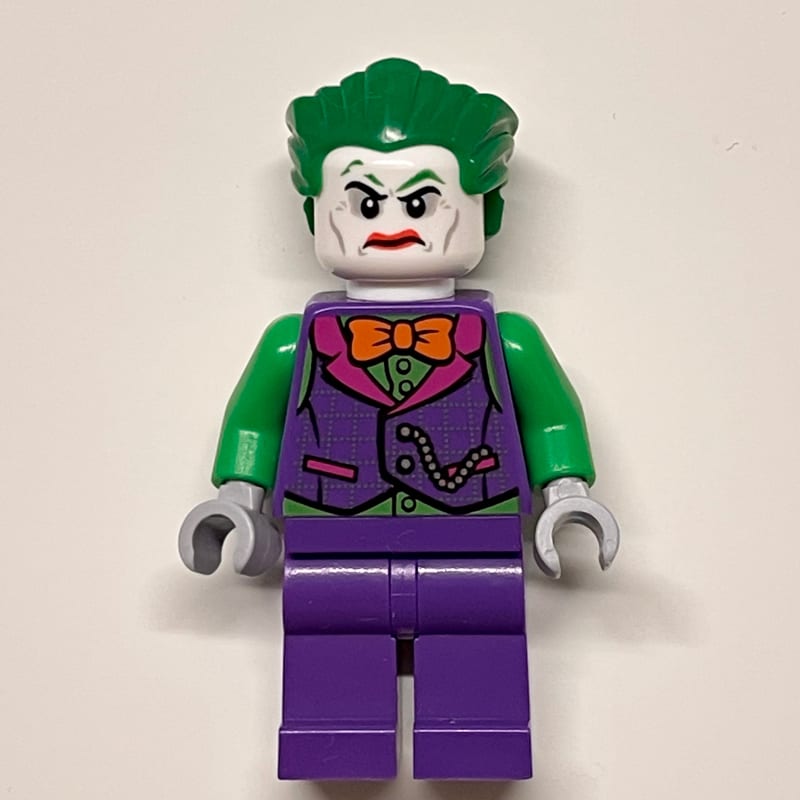 The Joker with Dark Purple Vest Over Green Shirt and Orange Bow Tie