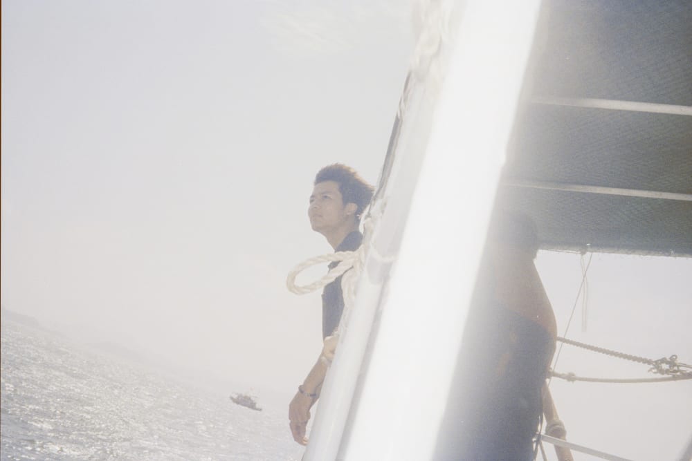 A person on a boat seen through a translucent curtain