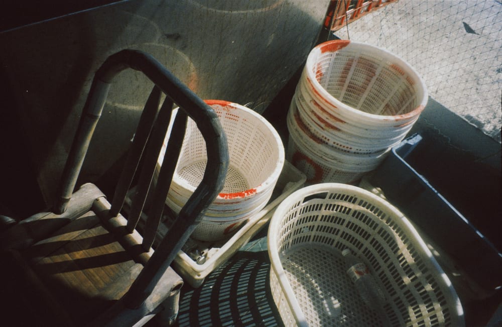 Baskets and a wooden chair on a boat