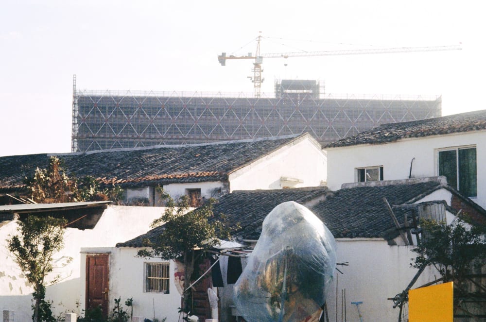 Old tiled rooftops below a construction site