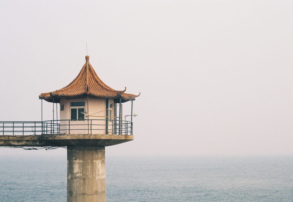 A golden-roofed pavilion over the sea