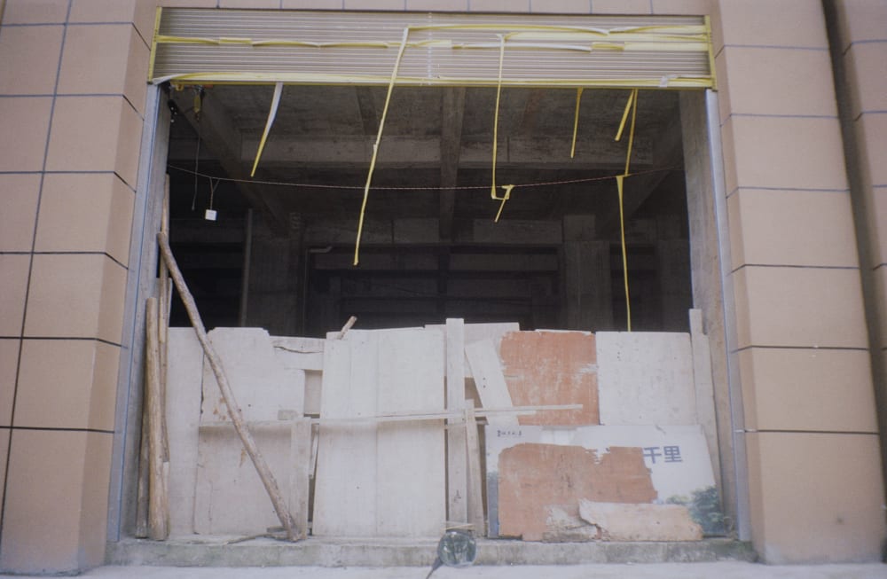 Boards leaning across a damaged shop entrance