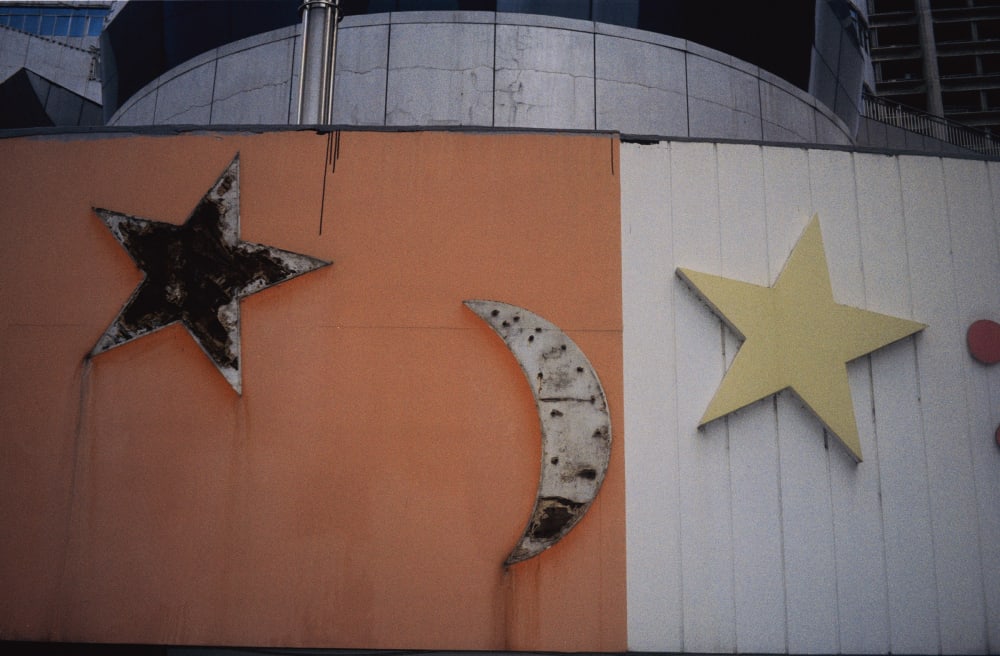 Stars and a crescent moon on an orange and white wall