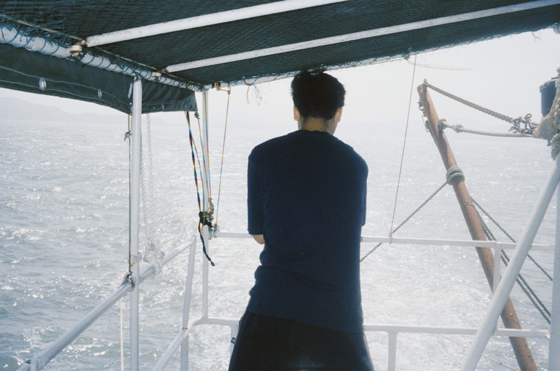 A person looking out over the sea from a boat