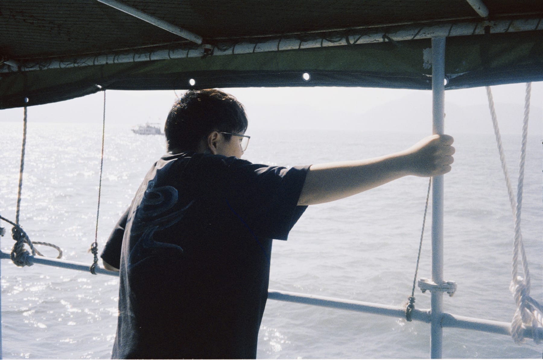 A person holding a boat canopy support
