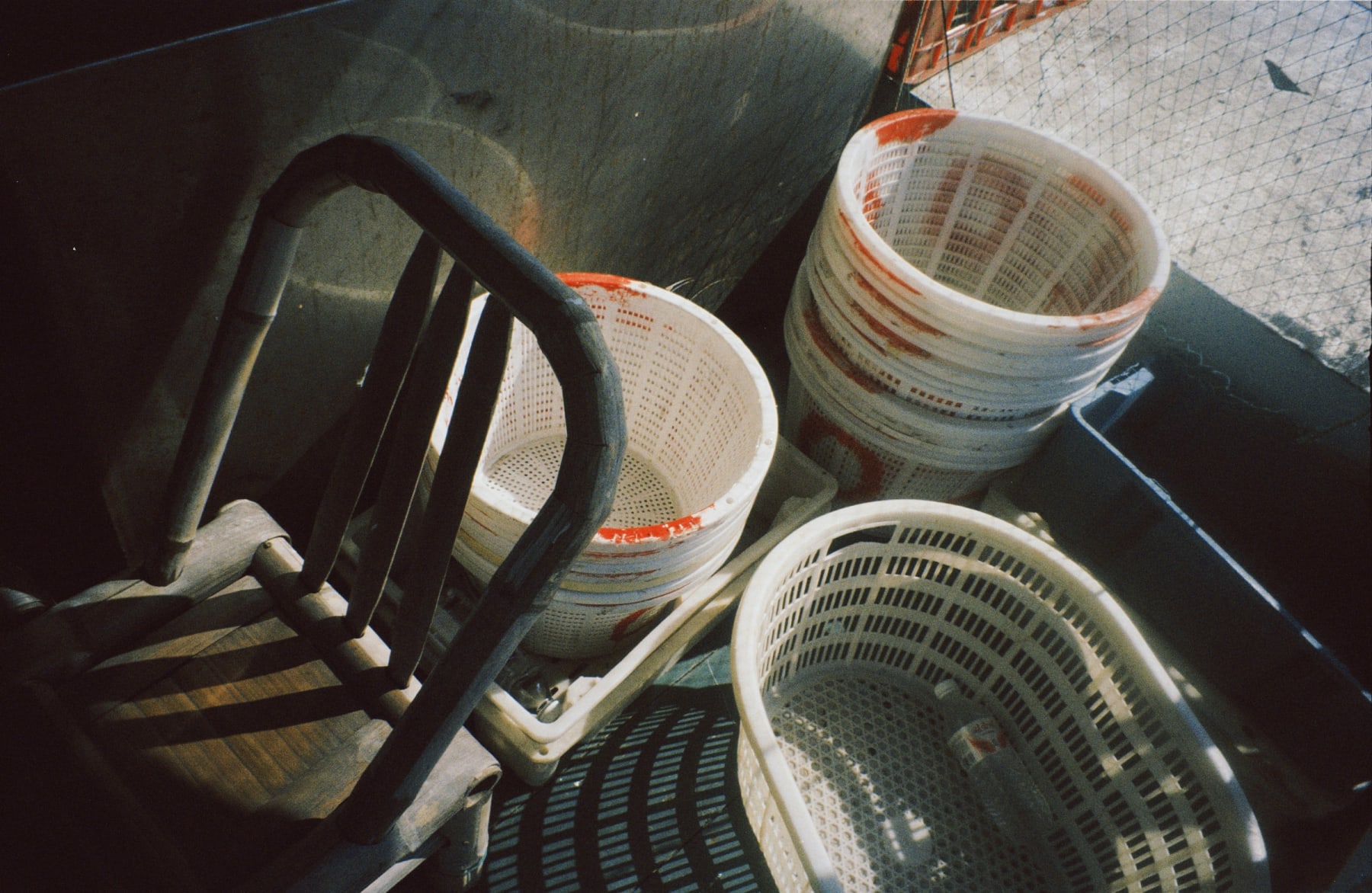 Baskets and a wooden chair on a boat