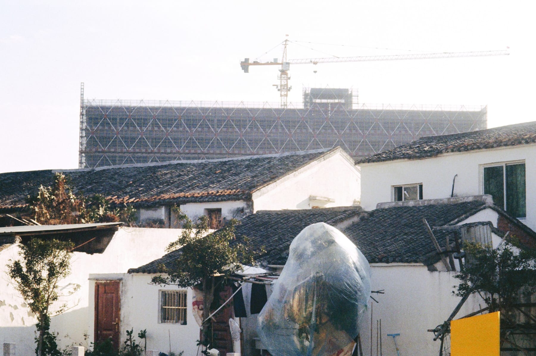 Old tiled rooftops below a construction site