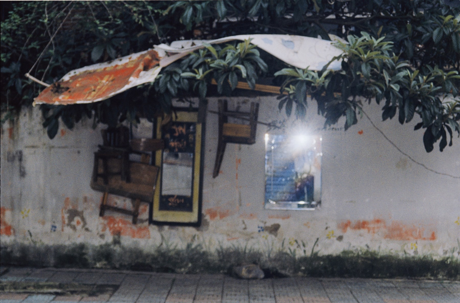 Sunlight reflected by a mirror on a weathered wall