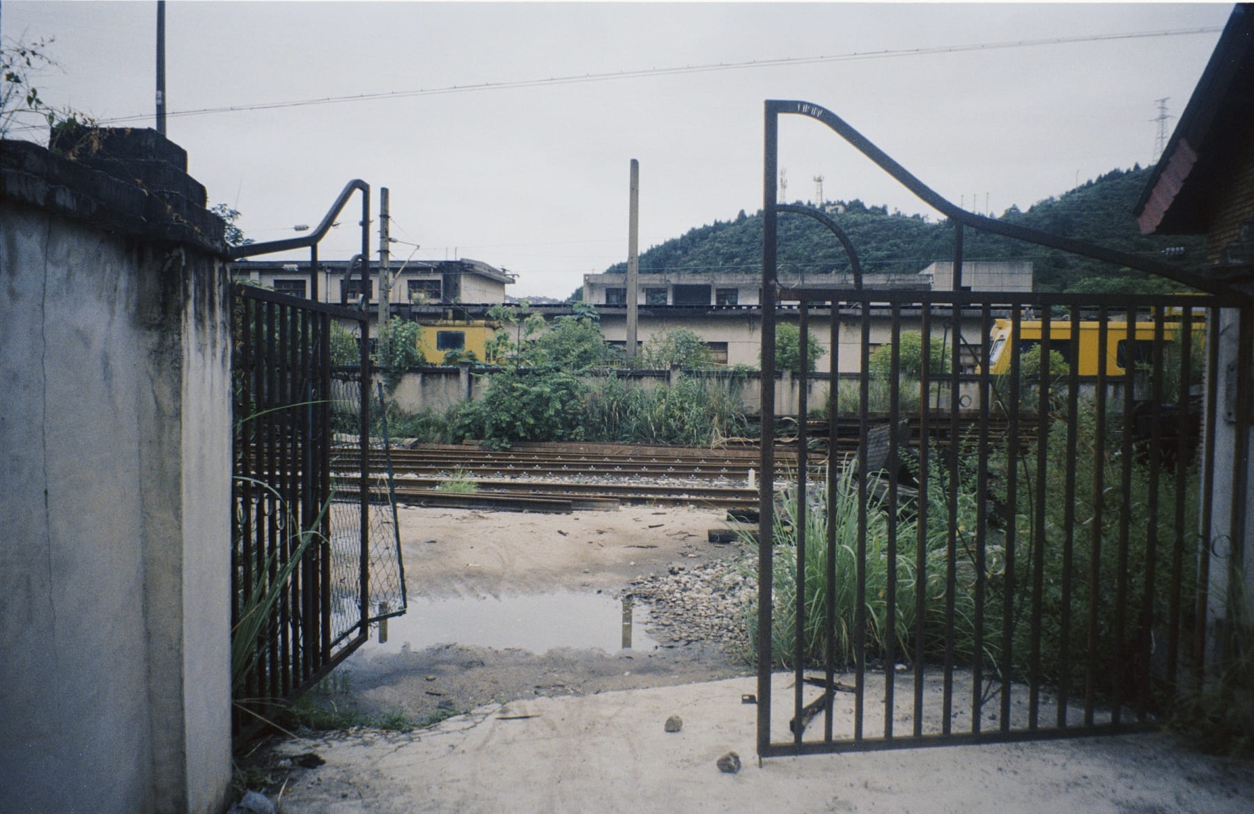 Open metal gates leading to railway tracks
