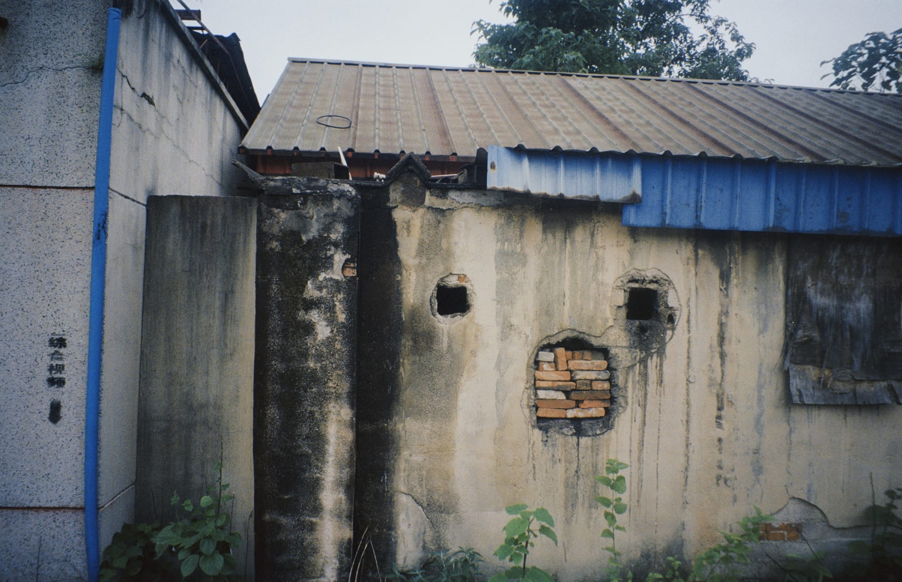 Openings and exposed bricks in a weathered wall